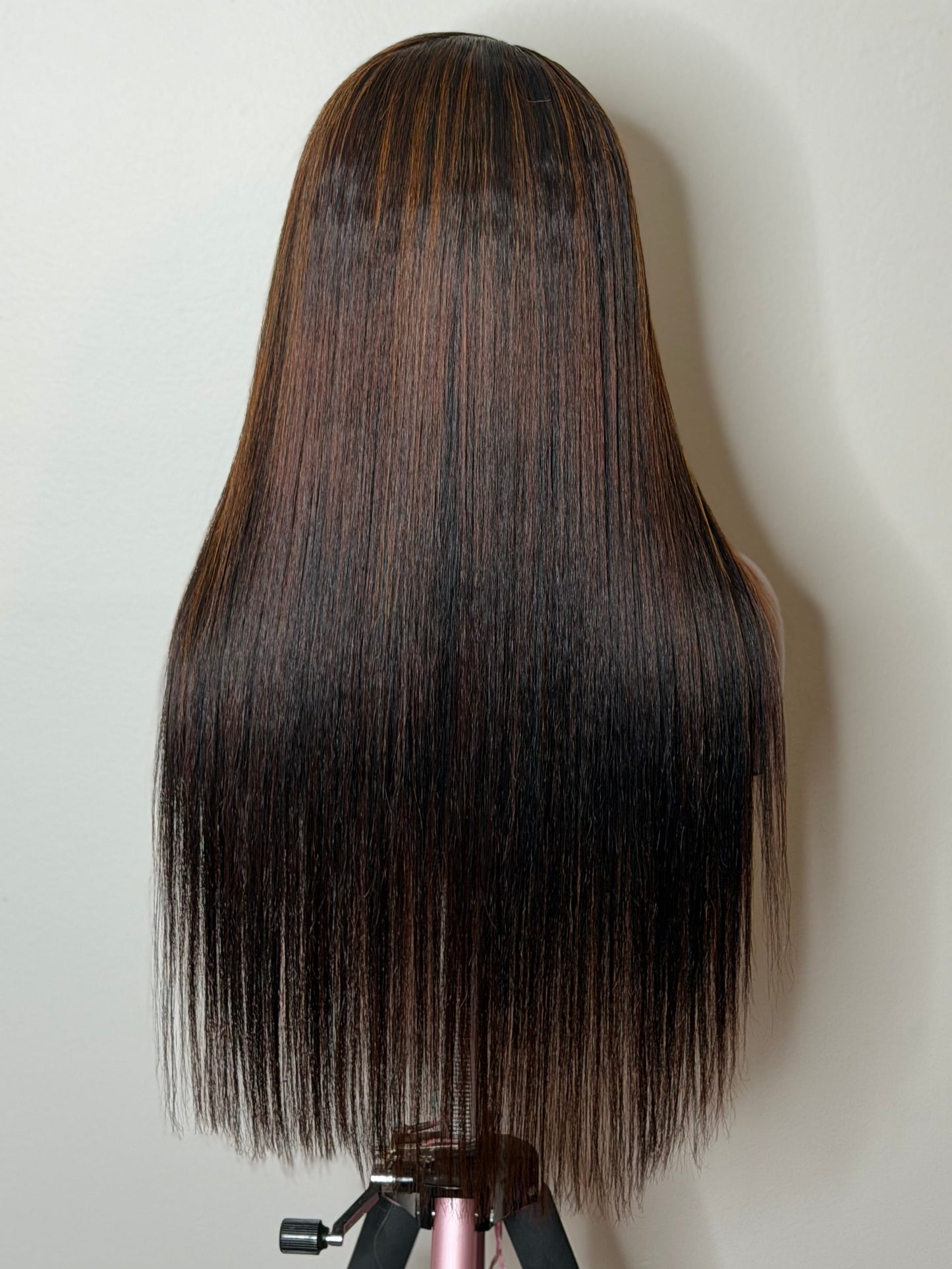 Back view of Sienna highlighting the long, full kinky straight texture and dimensional color blend.