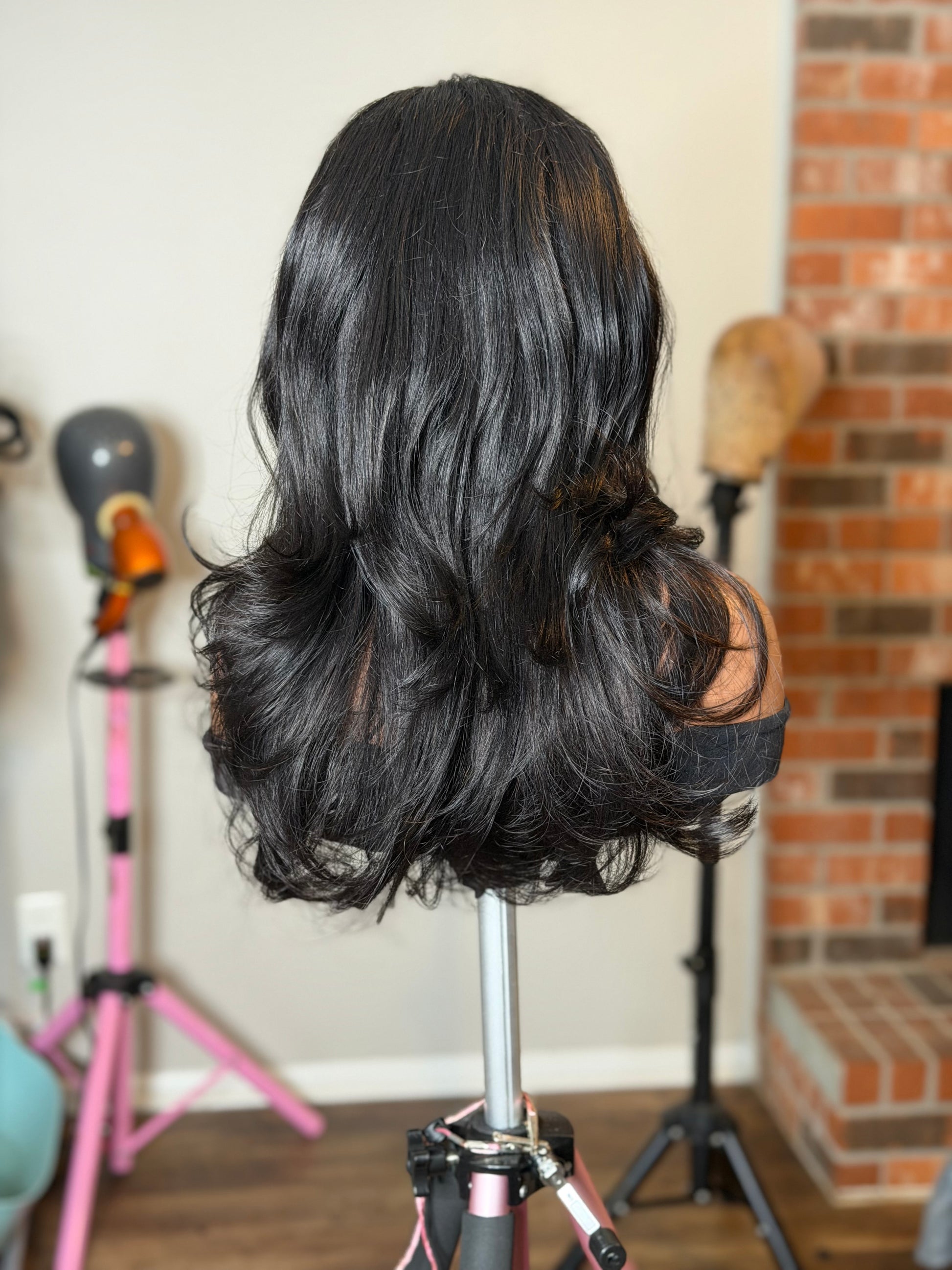 Back view of Jamila virgin human hair wig showing long layered blowout style.
