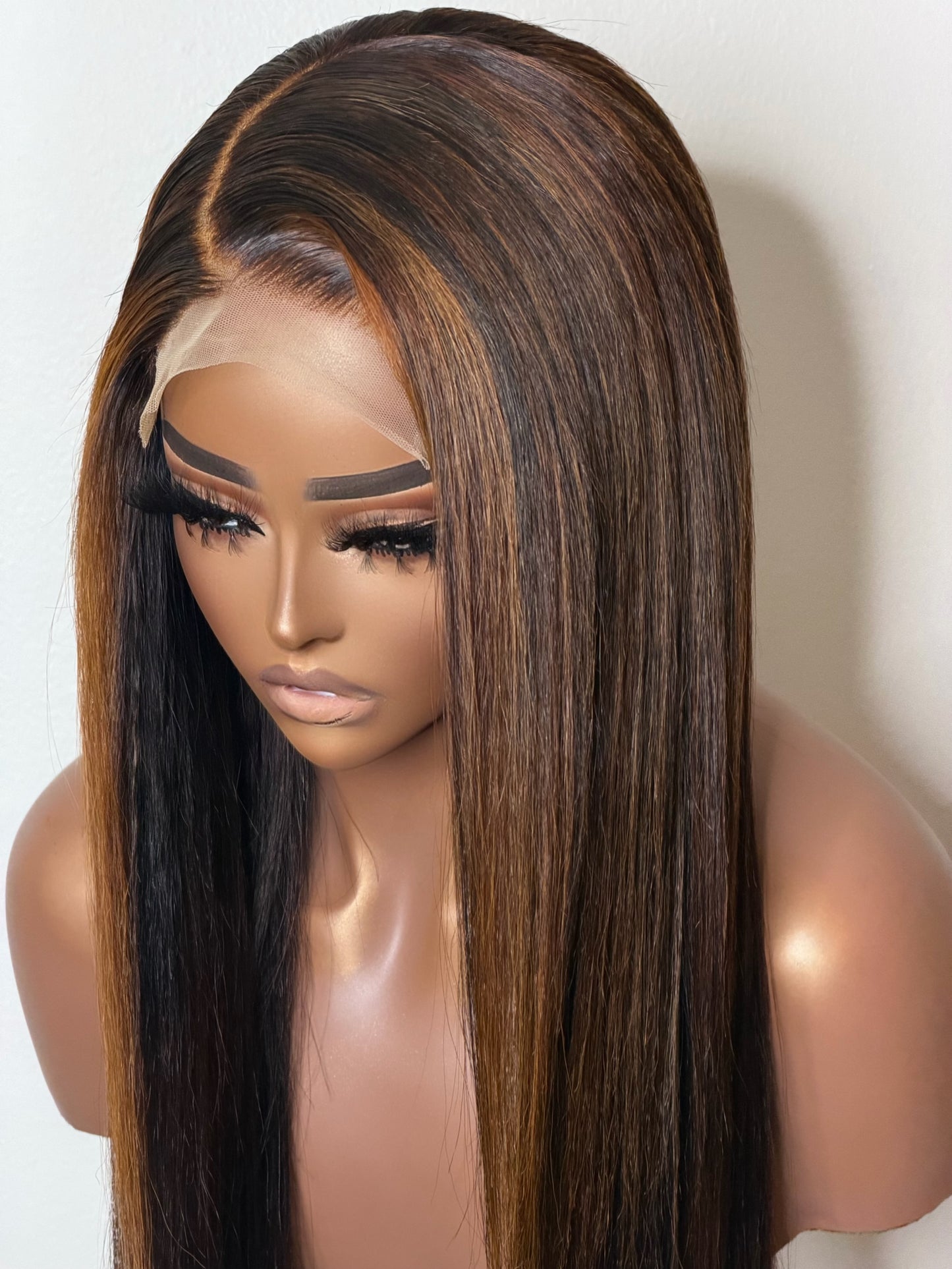 Close-up of Sienna’s transparent lace closure, lightly pre-plucked hairline, and custom-colored side part.