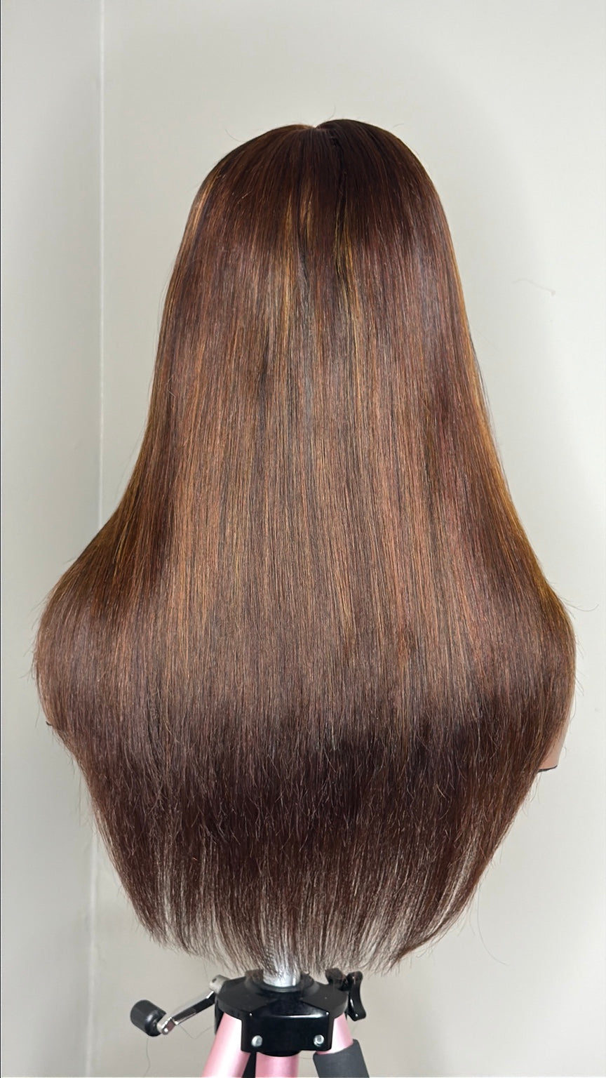 Dimensional brunette wig back view showing blended warm brown copper and golden tones