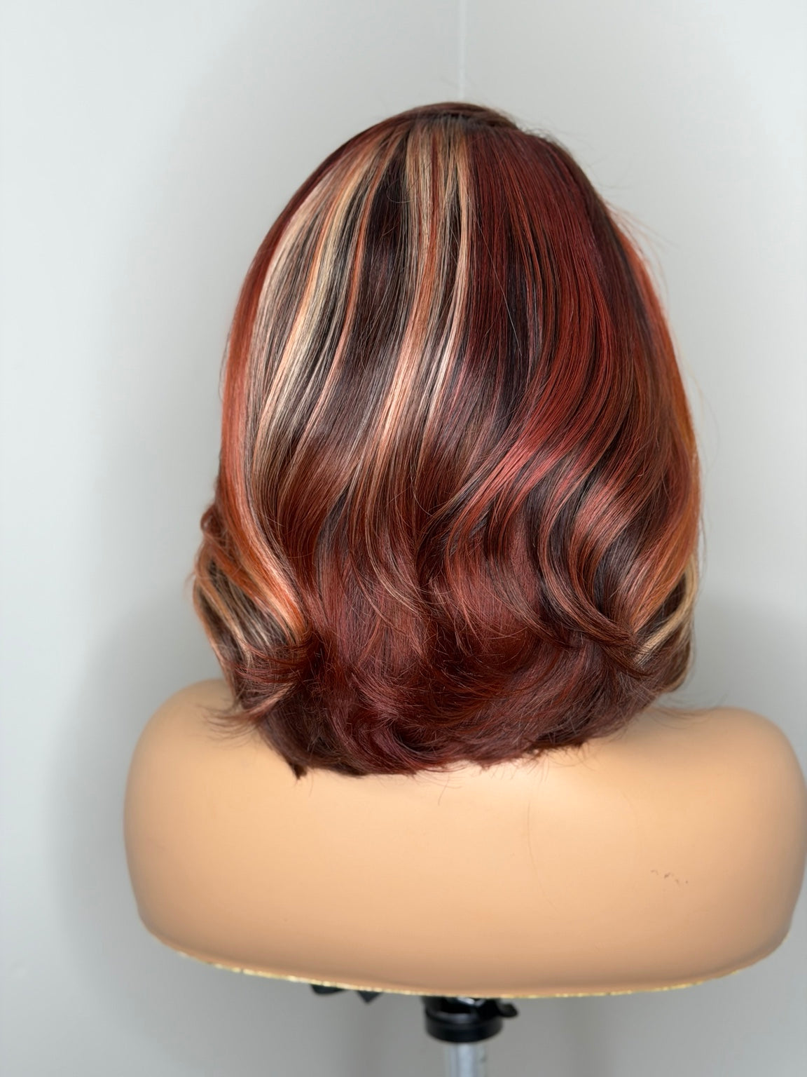 Back view of Safiya custom calico bob wig showing dimensional copper brunette and blonde ribbons