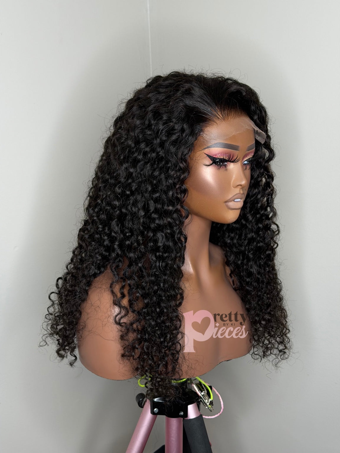 Zuri 22 inch Burmese curly wig angled view with Pretty Pieces by Ki logo