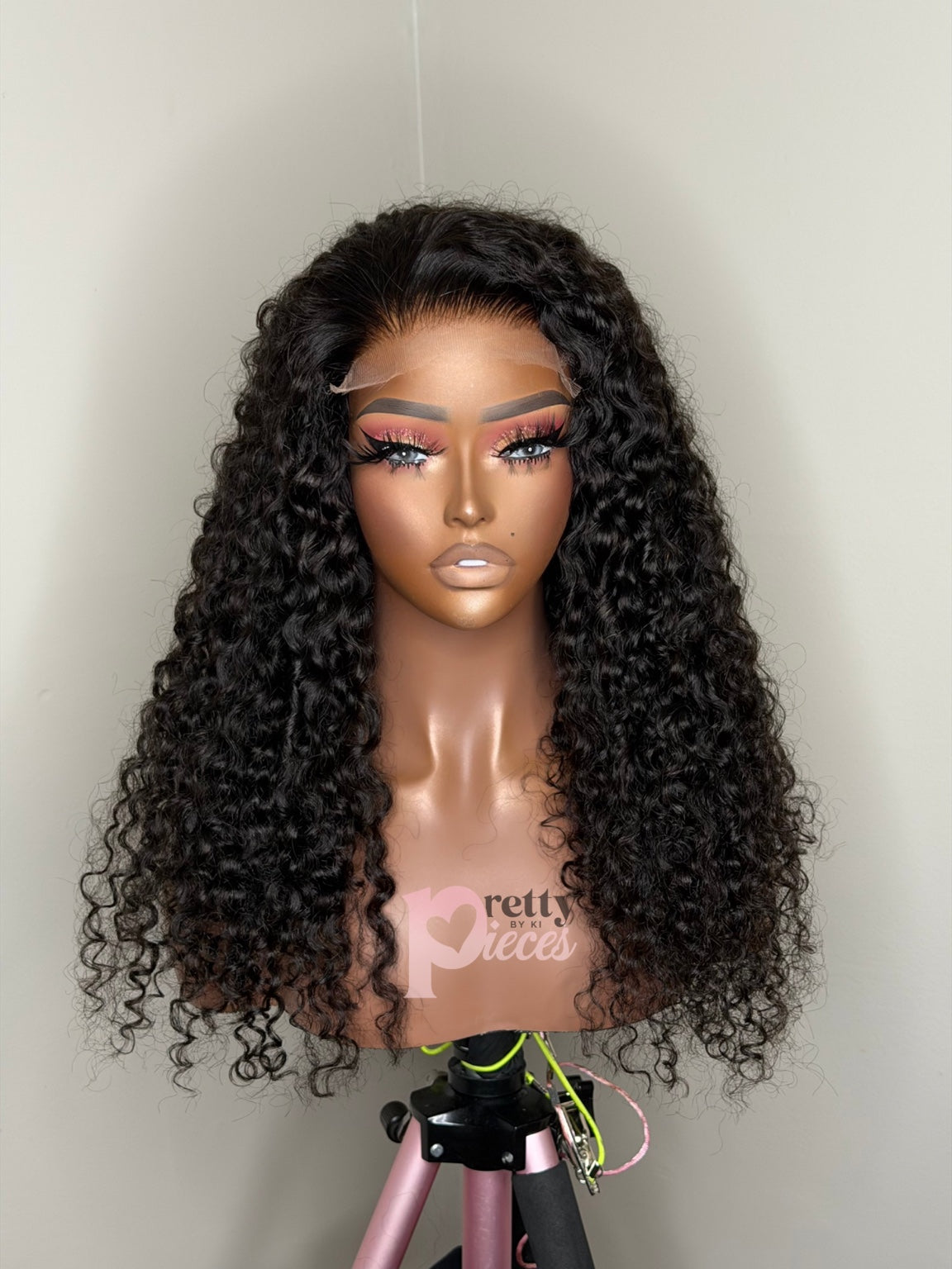 Zuri 22 inch Burmese curly wig front view with Pretty Pieces by Ki logo